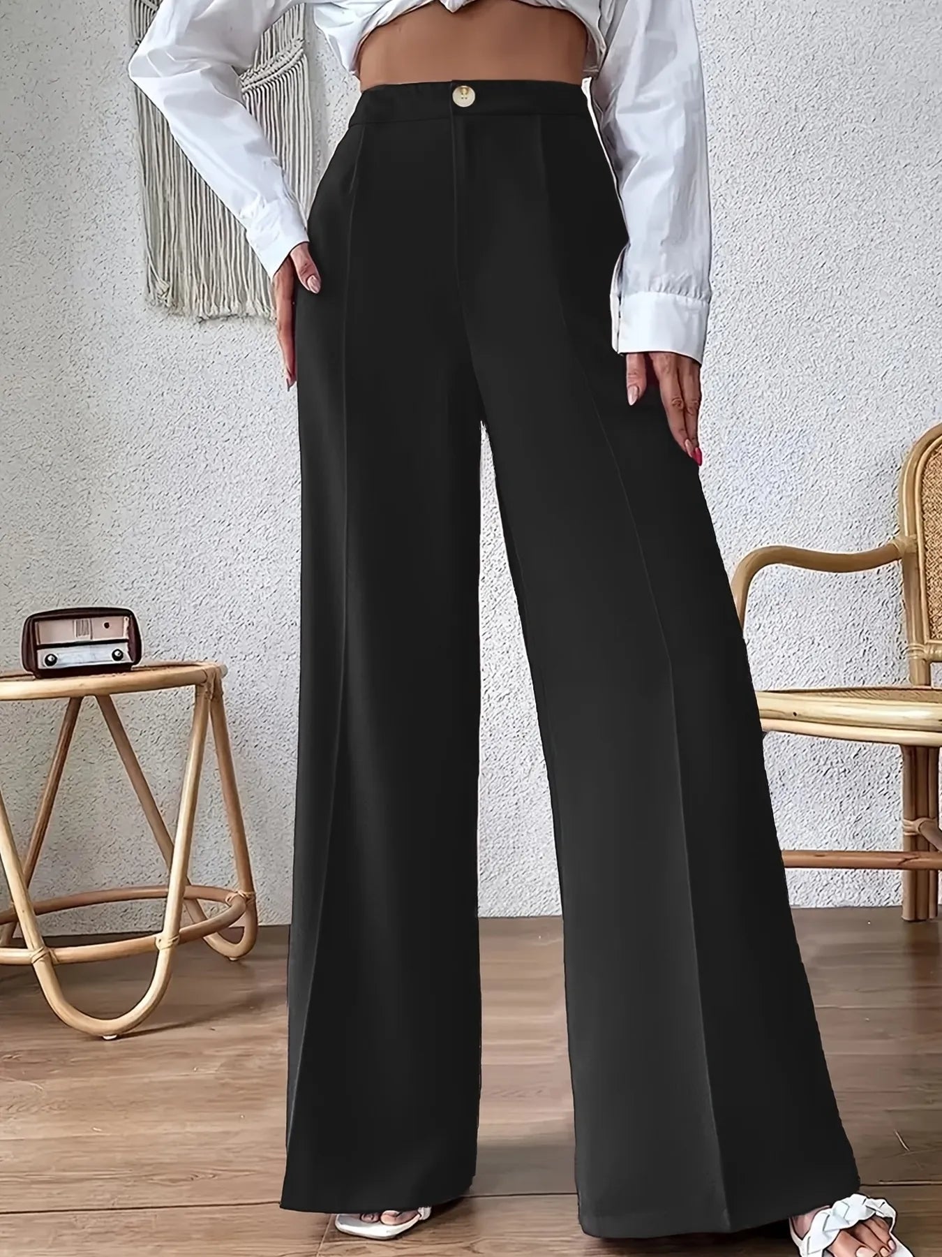 Black high-waist wide-leg pants with center button closure