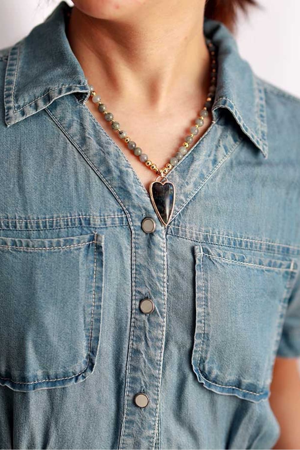 Beaded necklace with teardrop blue stone pendant and blue-gray beads with gold accents