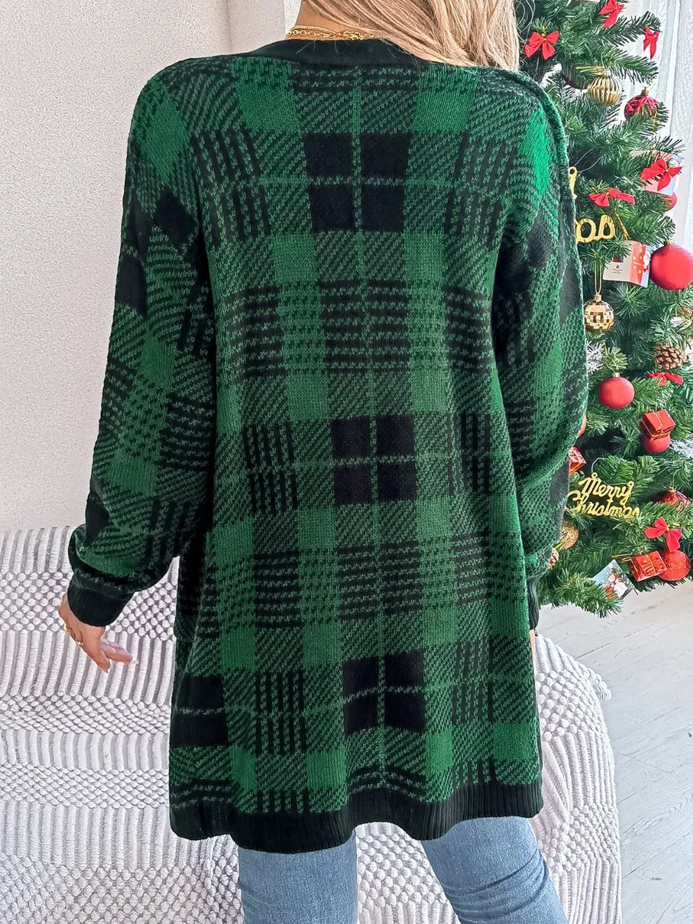 Back view of dark green and black plaid open-front long sleeve cardigan, long length