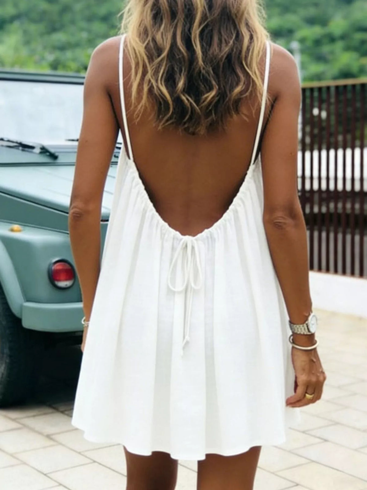 White backless mini dress with open back and tie detail at the center