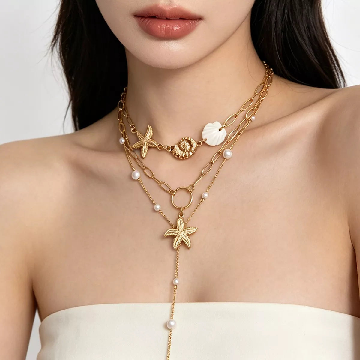 Gold layered starfish and seashell necklace with pearl bead drop and oval link