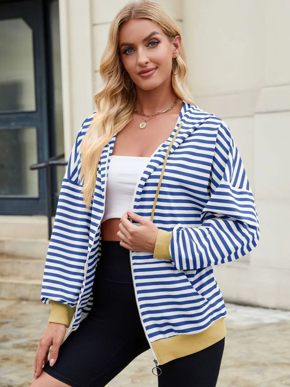 Blue-and-white striped zip-up hoodie with hood and drawstring, yellow cuffs.