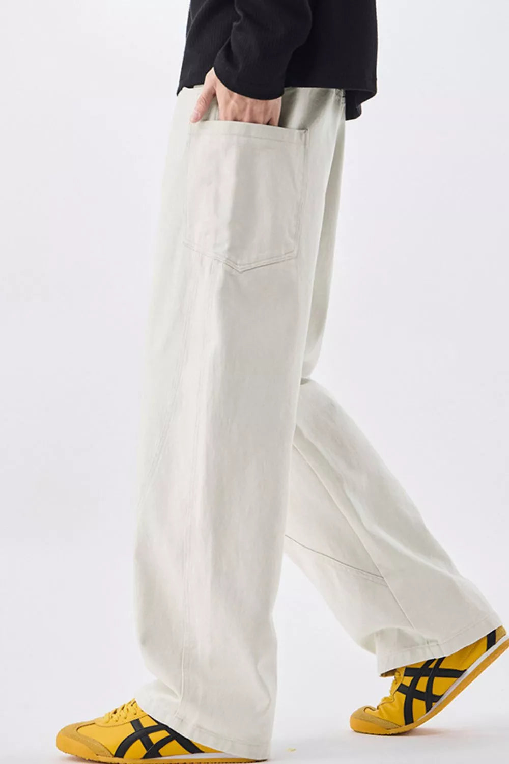 Off-white cotton drawstring waist jeans with relaxed wide-leg fit and front pockets