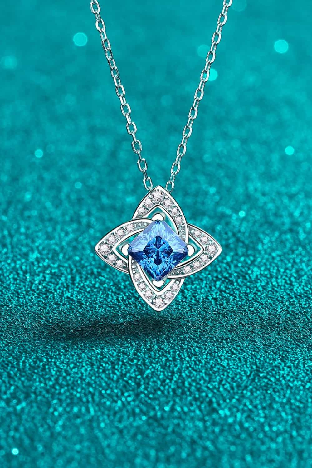 Silver-tone pendant necklace with sky-blue square-cut stone and diamond-like accents