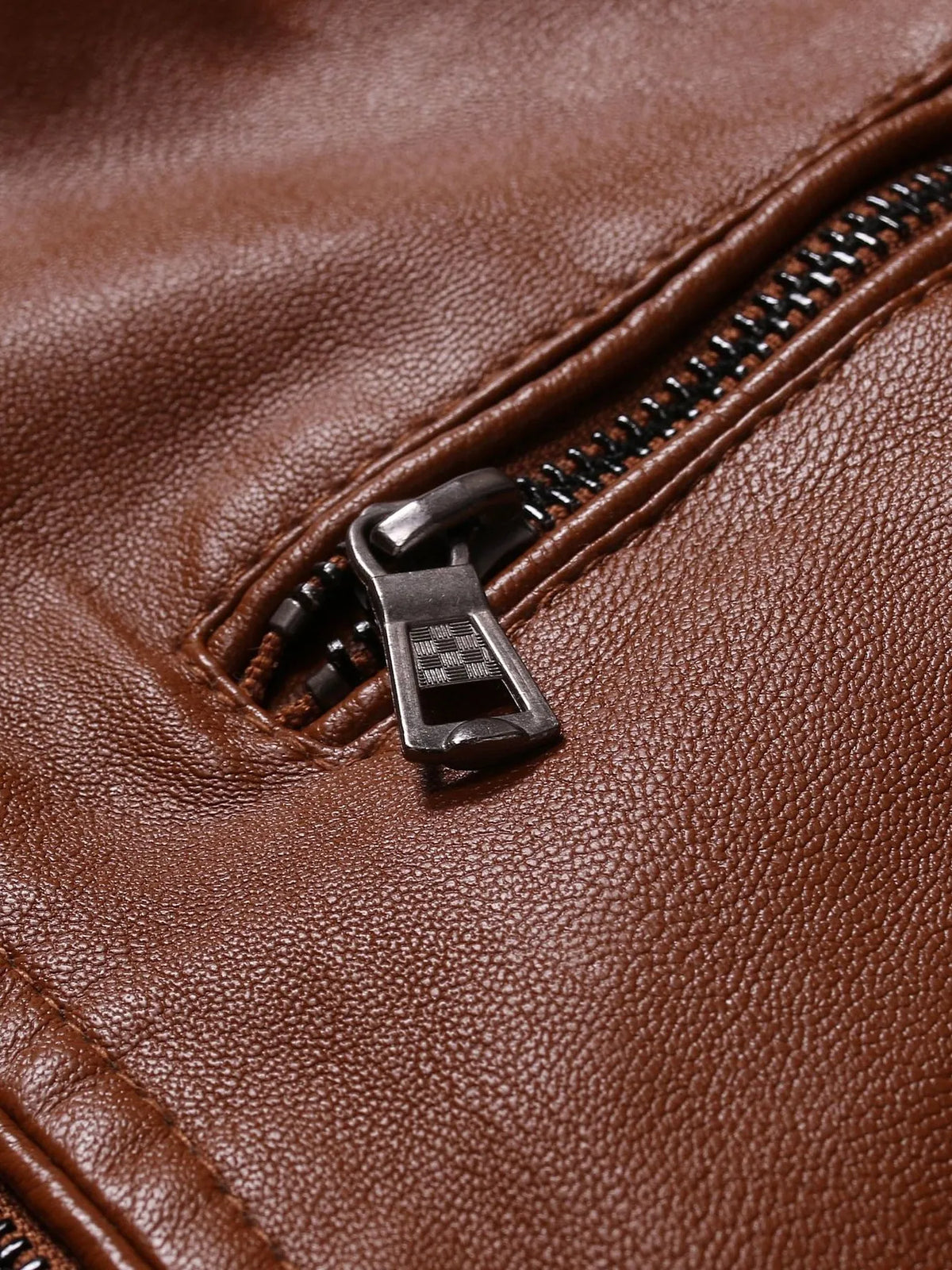 Brown leather motorcycle jacket zipper pull and pocket hardware detail