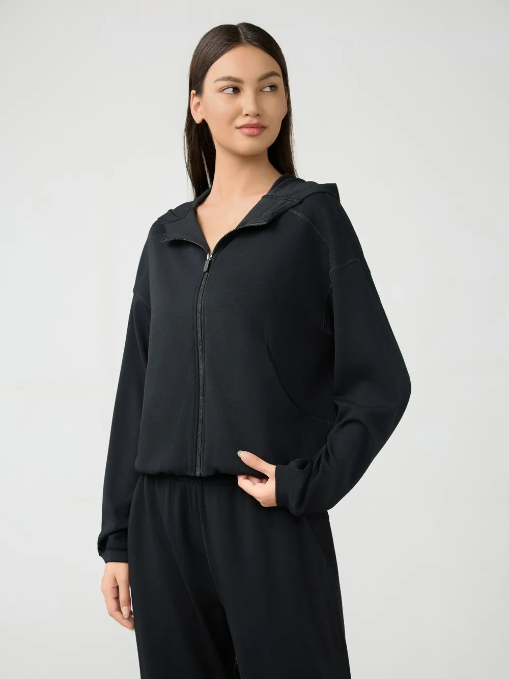 Black hooded zip-up active jacket with dropped shoulders and front zipper