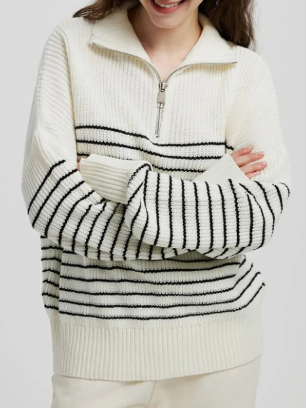 Cream striped half-zip knit sweater with long sleeves and ribbed cuffs, front zip placket