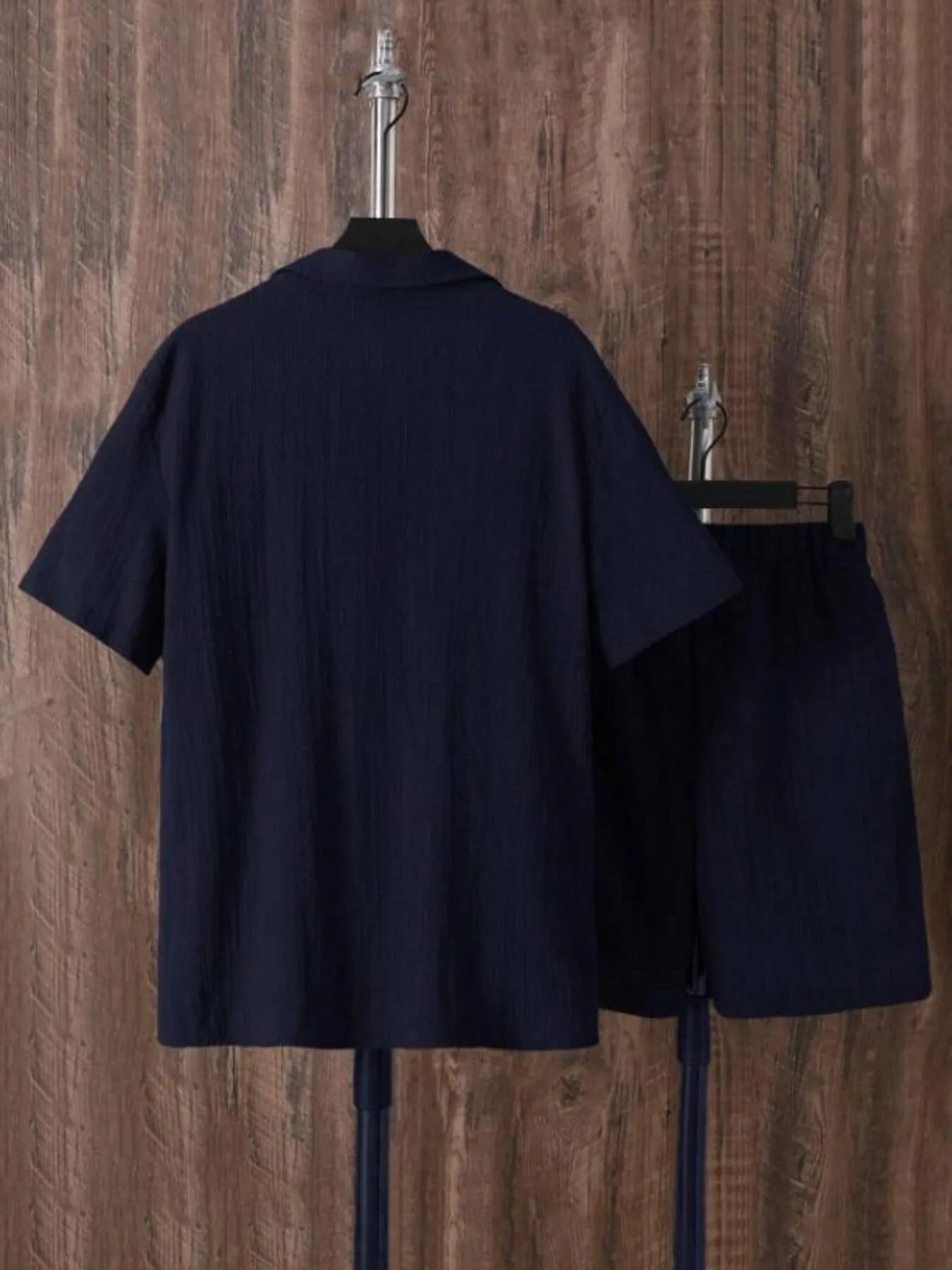 Back of men's plus size navy short sleeve button-up shirt and matching shorts set