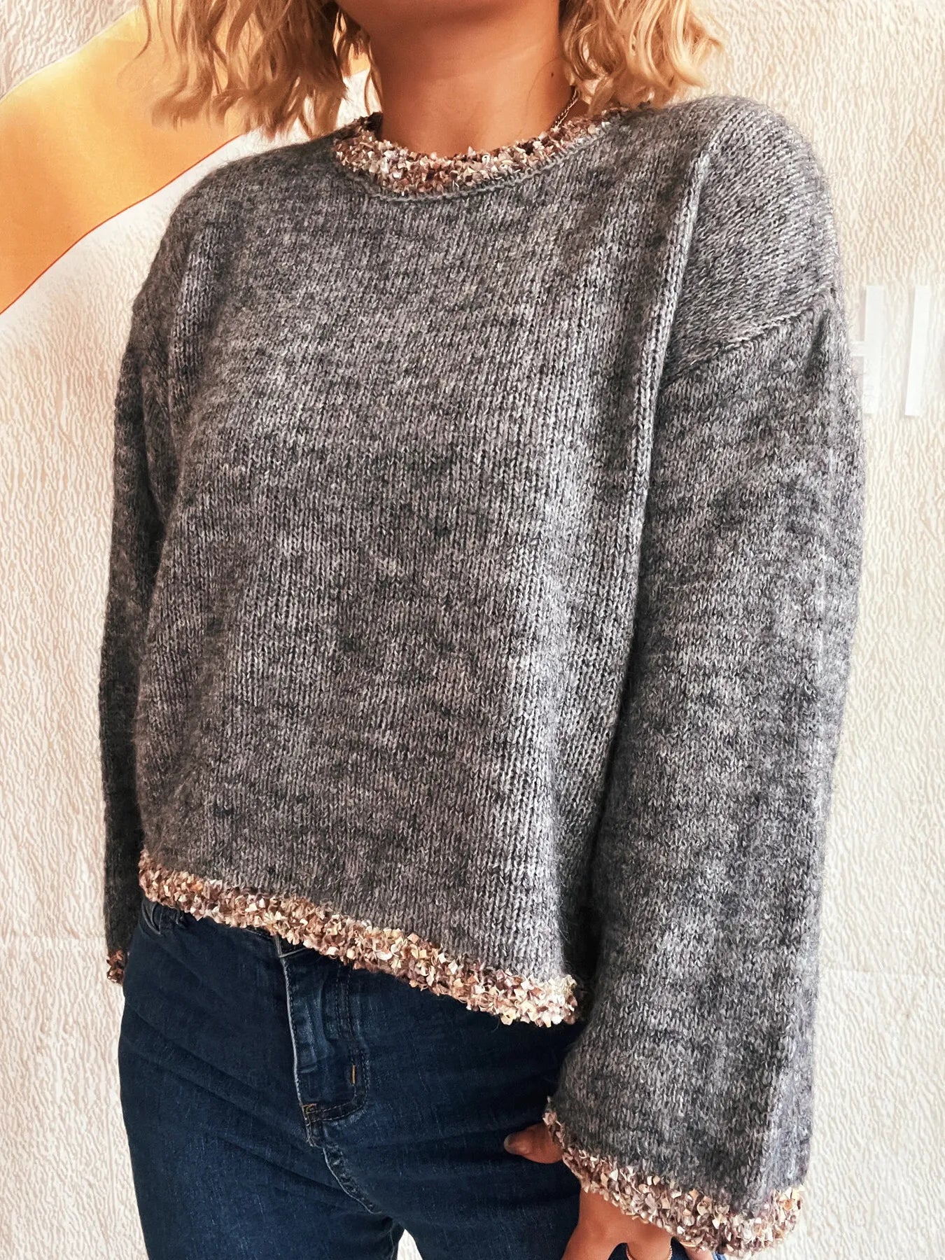 Dark gray cropped round-neck sweater with rose-gold sparkling trim at hem and cuffs