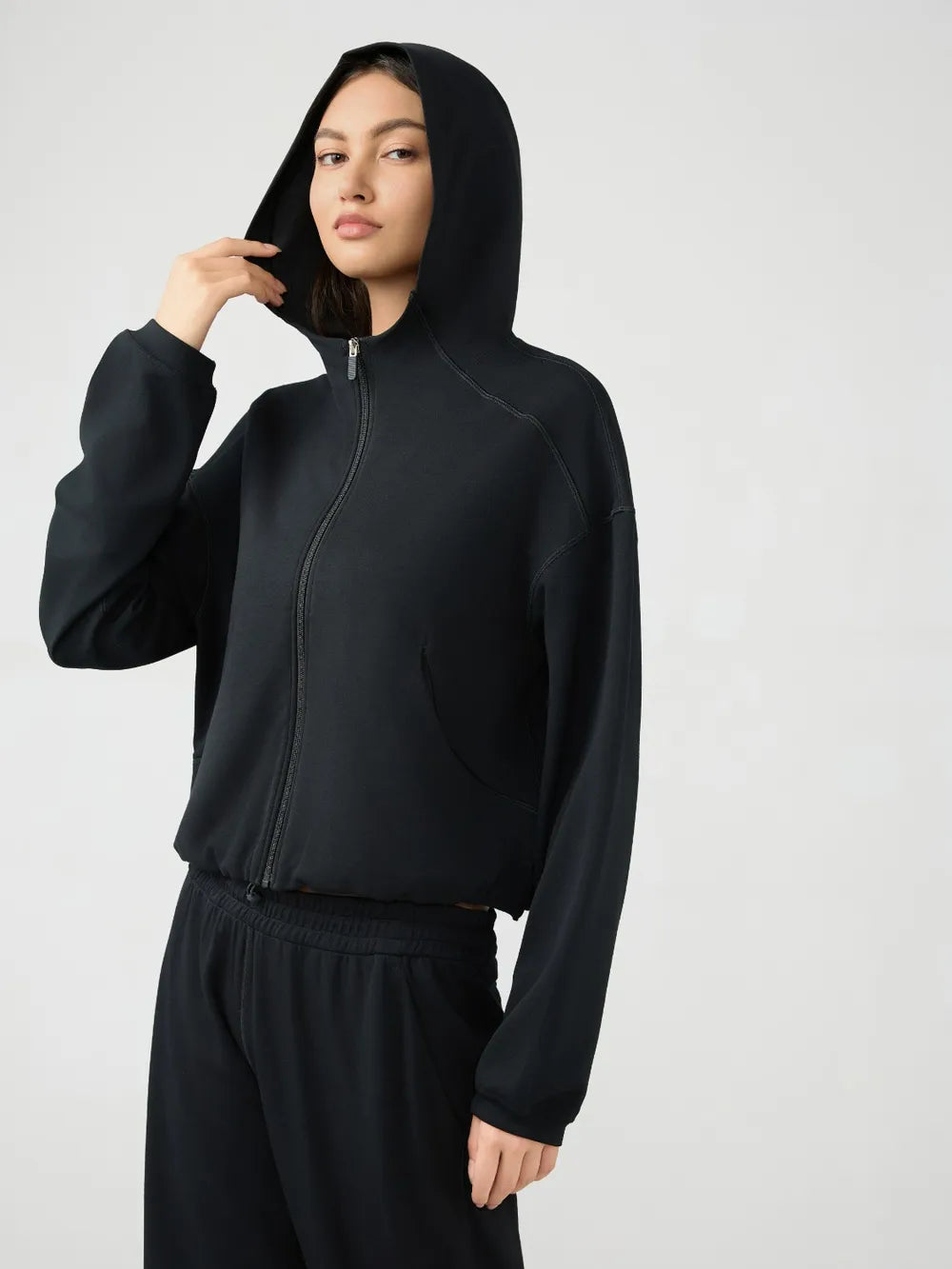 Black hooded active zip jacket with dropped shoulders, front view