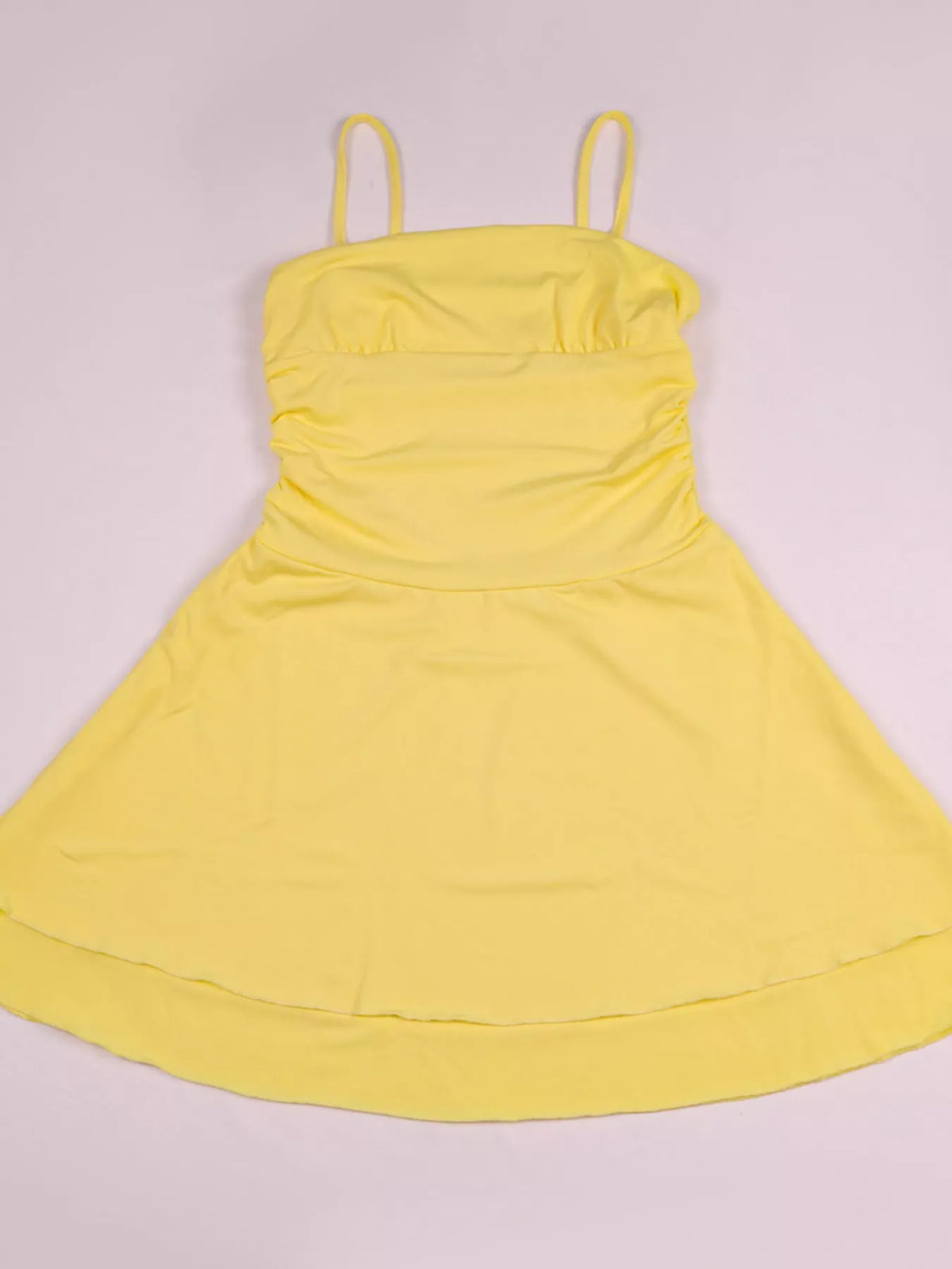 Yellow ruched layered spaghetti-strap mini dress, front view on mannequin