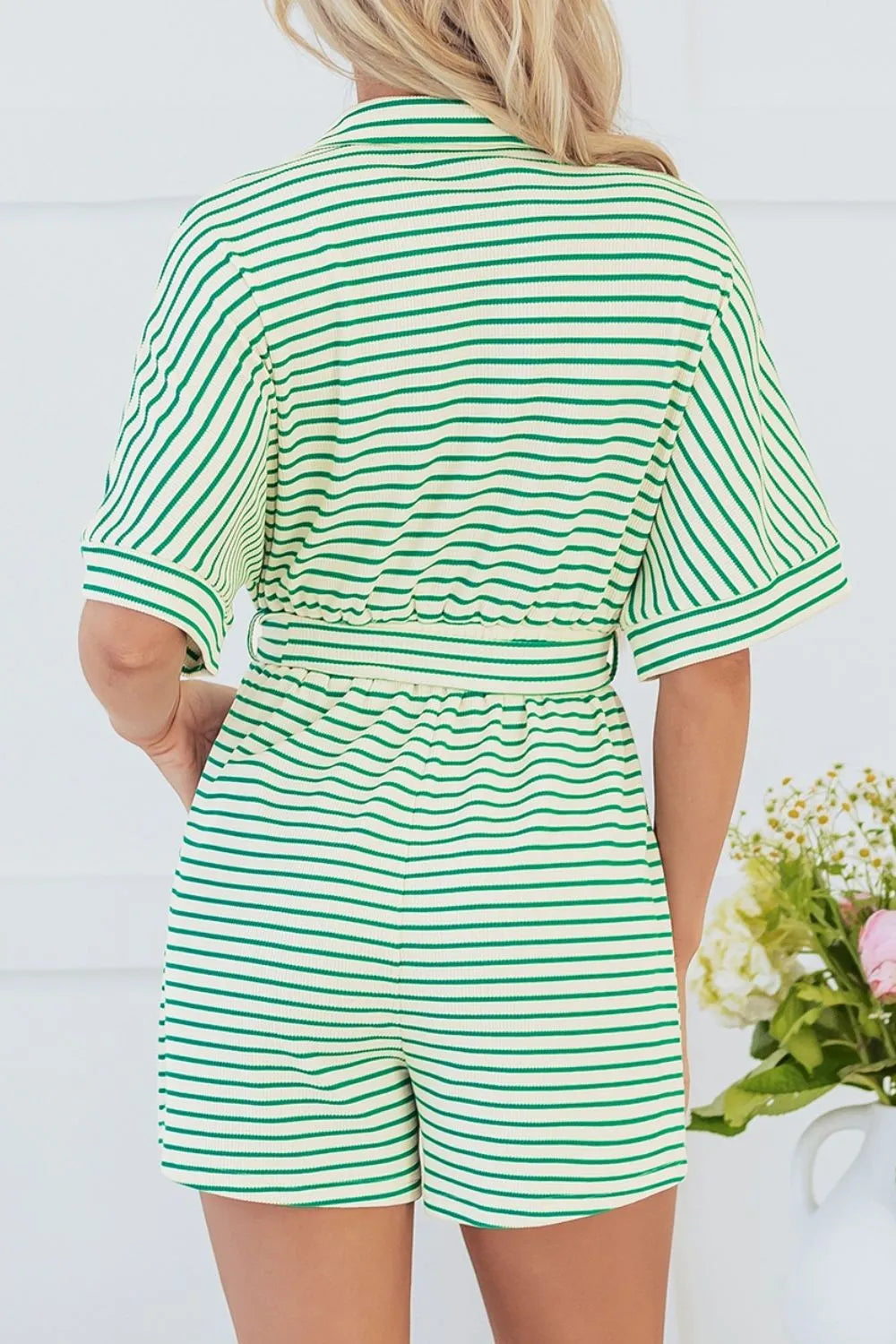 Green and white striped half-sleeve romper, back view with belted waist tie