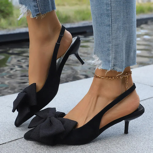 Black bow point-toe kitten heels with thin ankle strap and high stiletto heel