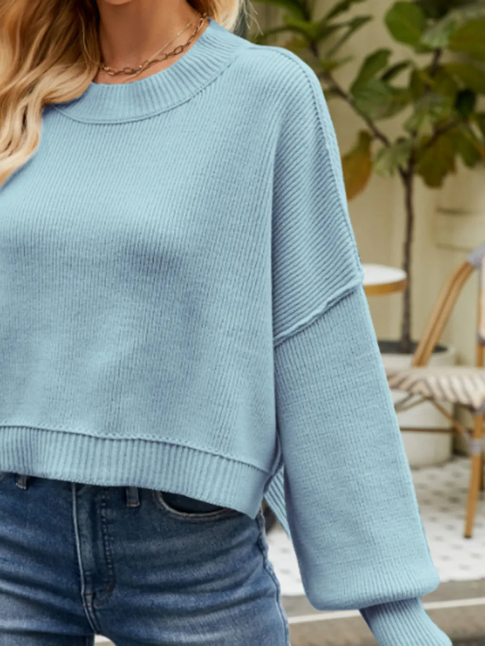 Misty blue lantern sleeve sweater close-up with ribbed round neck and hem
