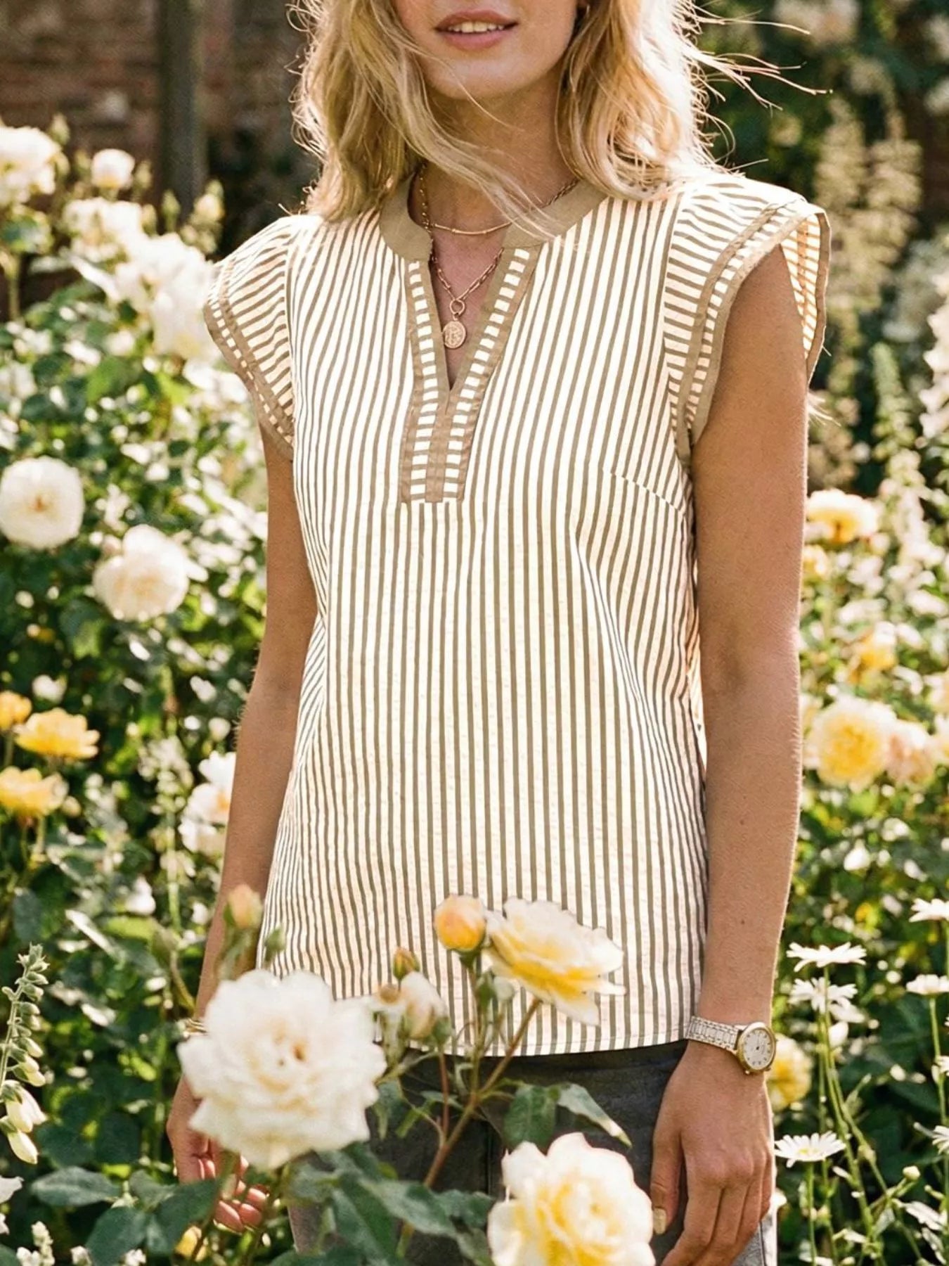 Striped Ruffle Sleeve Blouse in beige and white with vertical stripes; lightweight, relaxed-fit top with cap ruffle sleeves