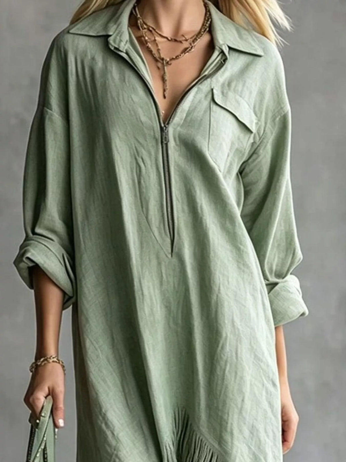 Sage green midi dress with half-zip front and fringe trim at hem