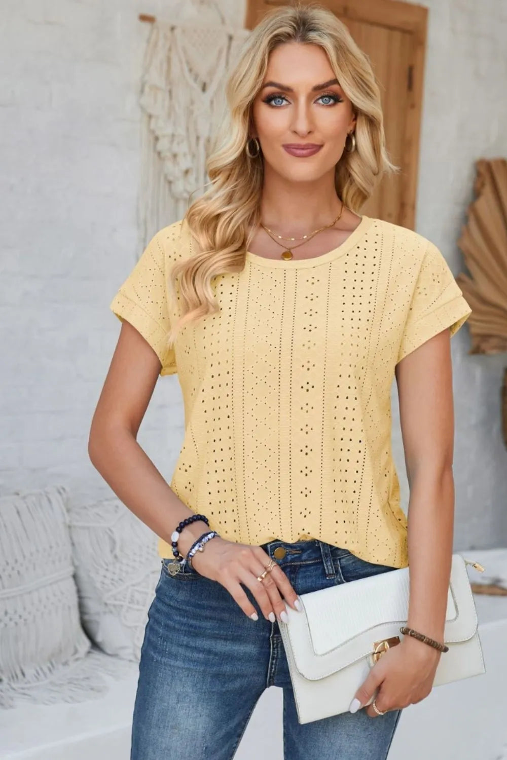 Light yellow eyelet short-sleeve T-shirt with round neck and rolled sleeves