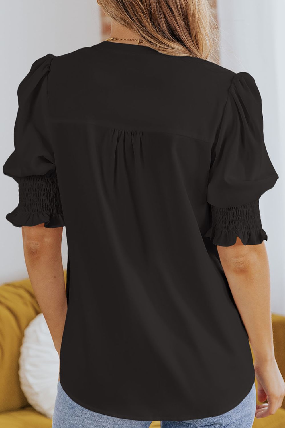 Back view smocked flounce sleeve blouse, black with gathered puff sleeves and smocking