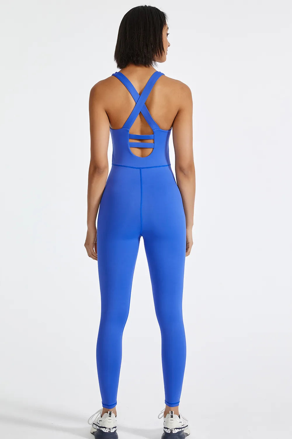 Blue active jumpsuit with crisscross wide back straps and open back detail
