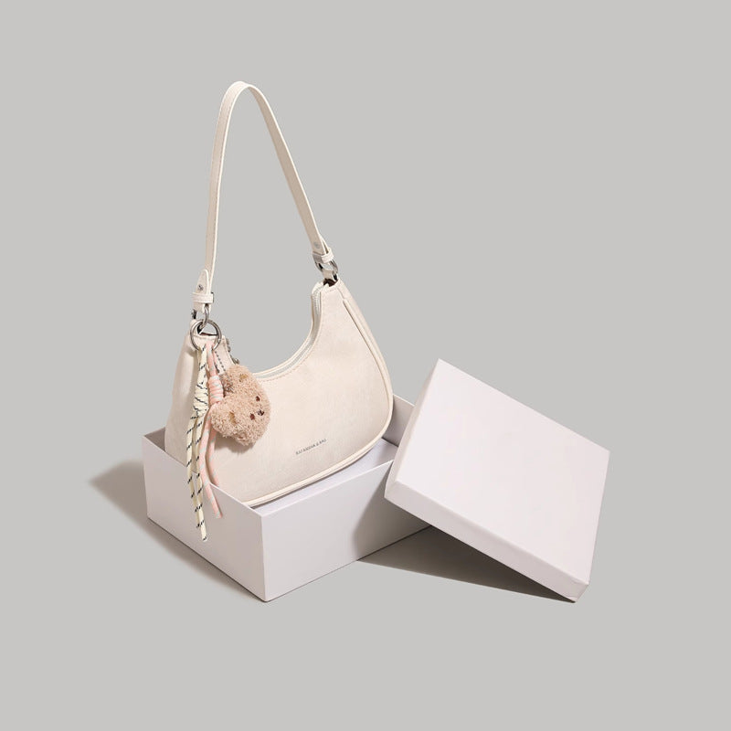 Crescent shoulder bag with teddy bear charm in cream PU, mini size by Trendsi