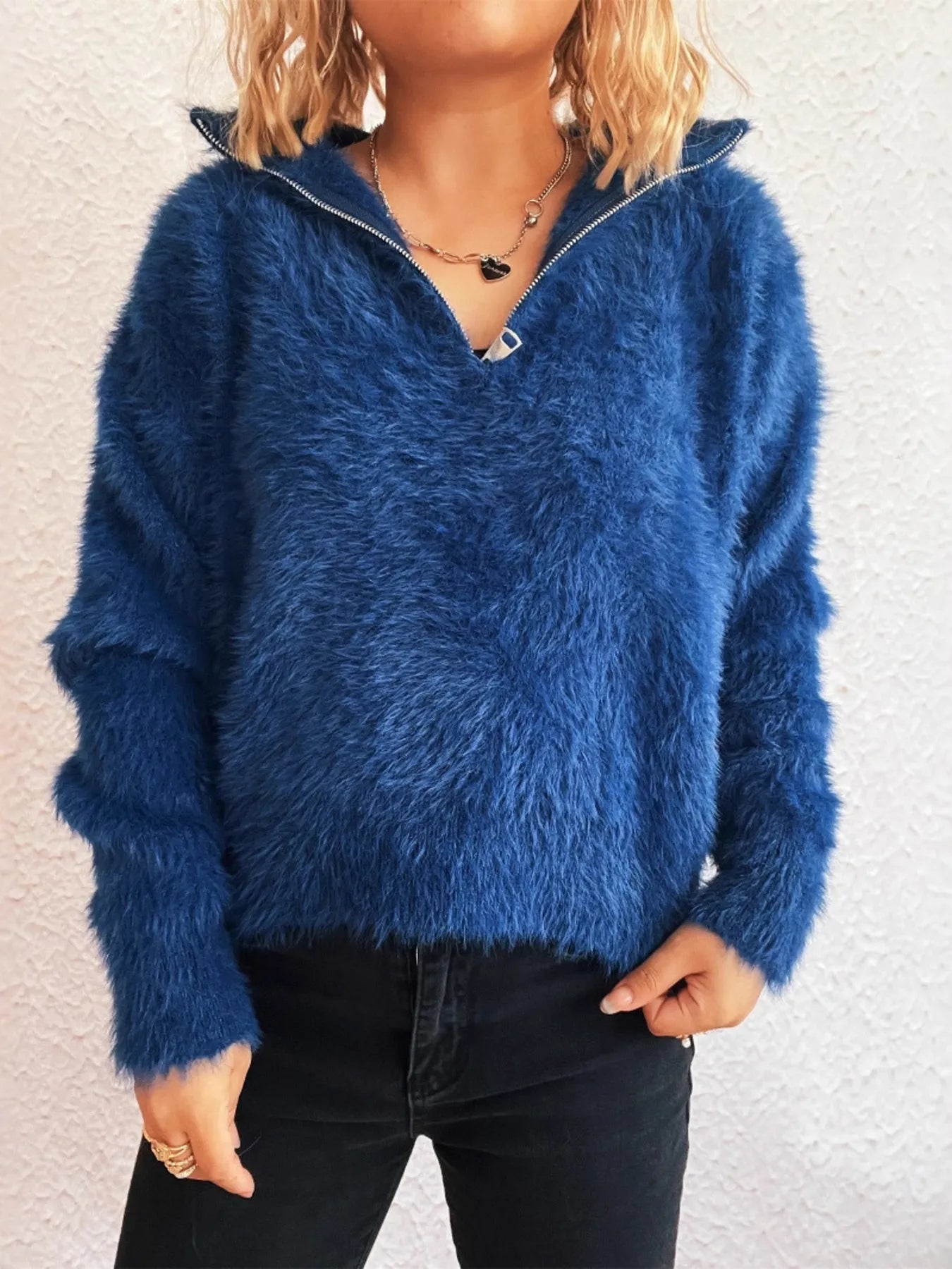 Blue fuzzy half-zip sweater with long sleeves and half-front zipper