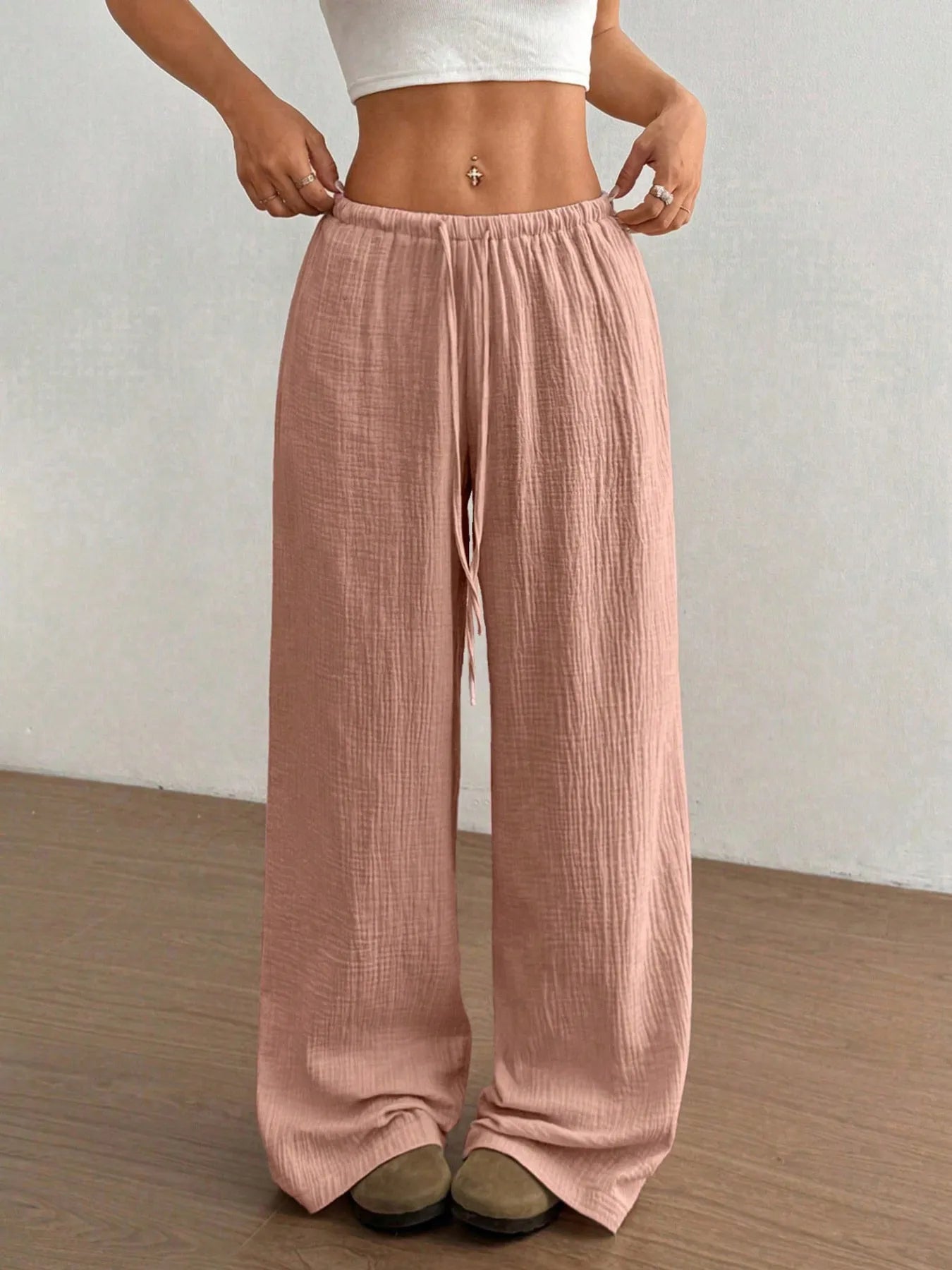 Dusty pink wide-leg drawstring pants with gathered elastic waistband and roomy fit