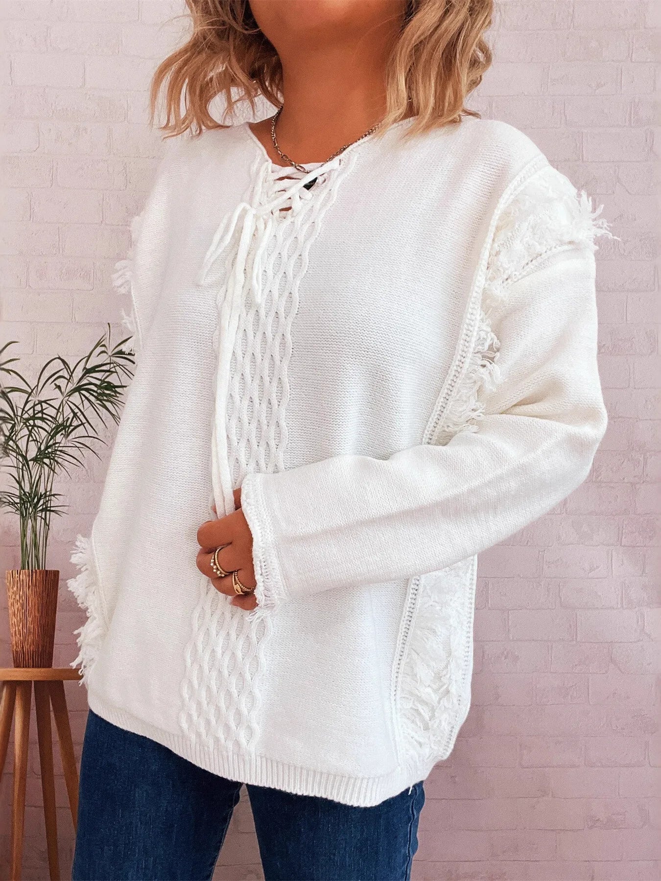 White lace-up front sweater with cable knit pattern and textured knit tie