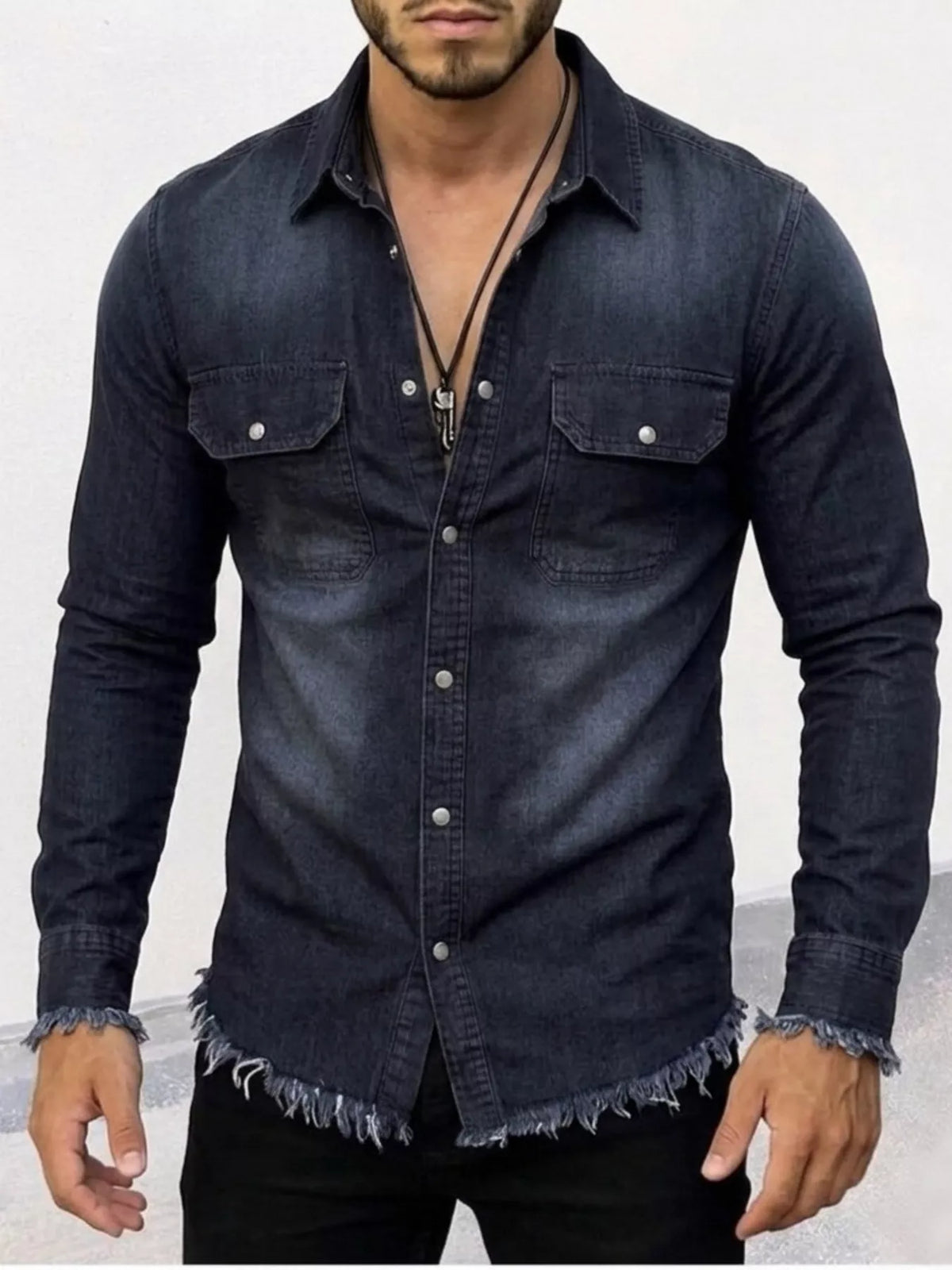 Dark denim button-up shirt with two chest pockets, frayed cuffs, and frayed hem