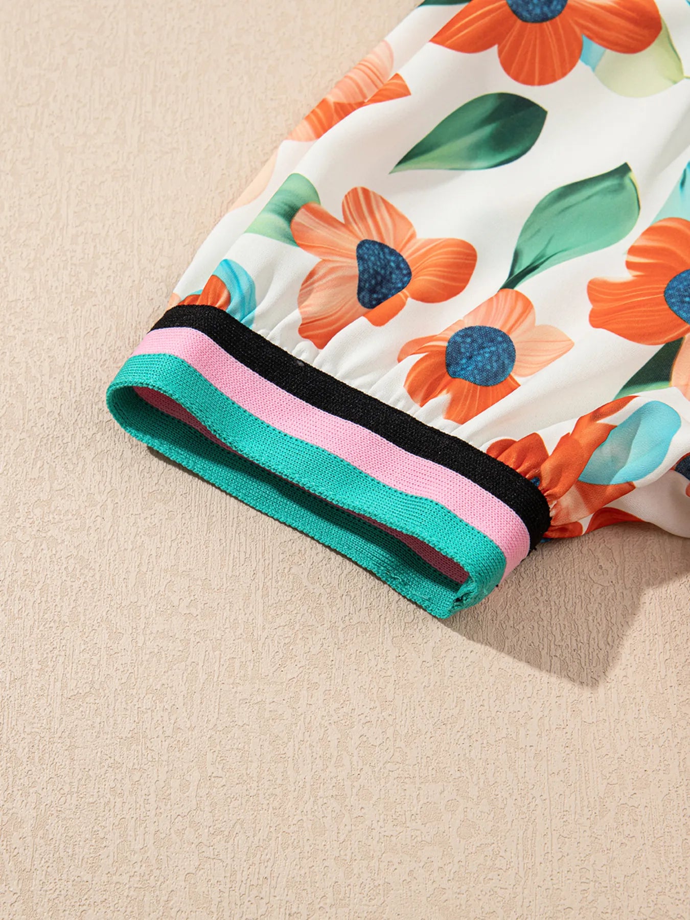 Dress: floral print mini with puff sleeves and teal-pink-black striped cuff.