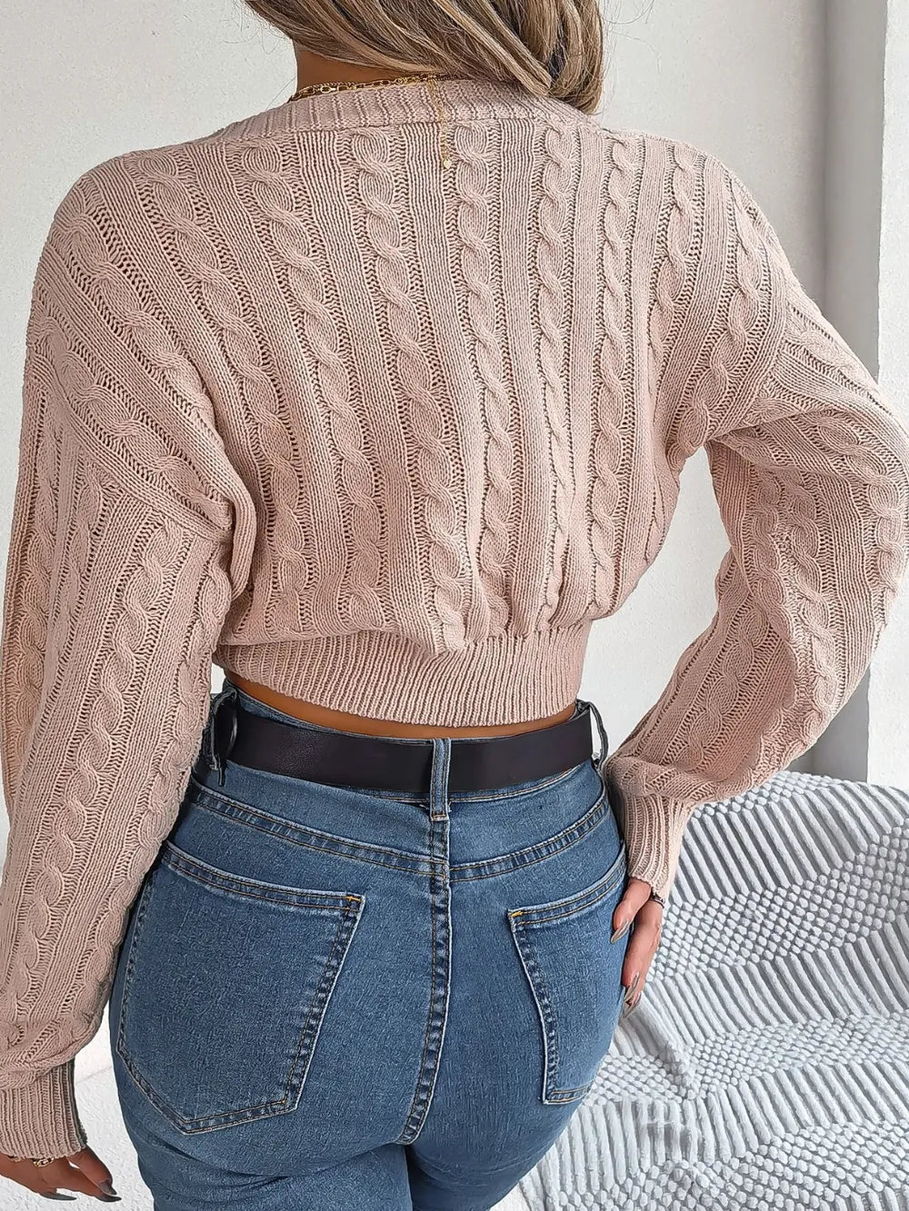 Blush pink twisted cable-knit V-neck sweater, long sleeves, back view