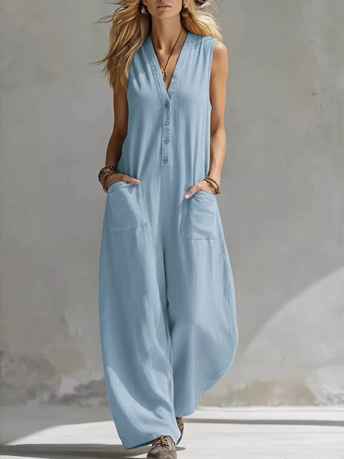 Light blue V-neck sleeveless wide-leg jumpsuit with button front and side pockets