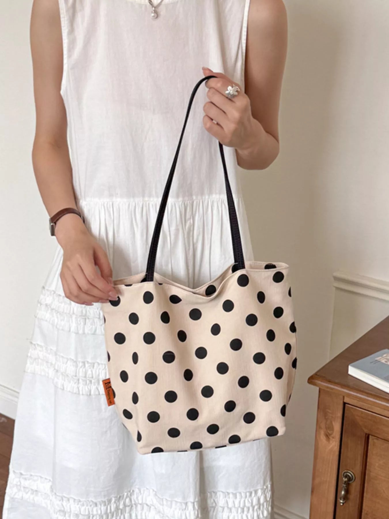 Medium polka dot shoulder bag in cream with black dots and black top handles