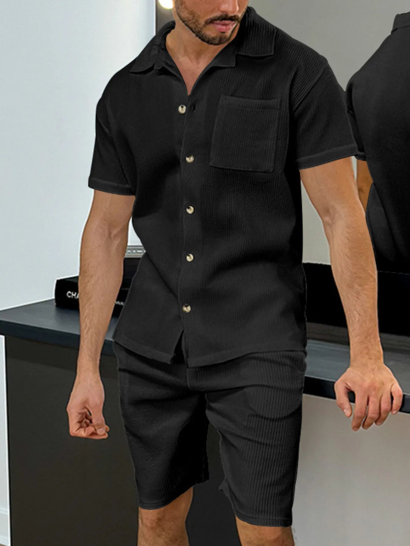 Men's black button-up short-sleeve shirt with chest pocket and matching shorts
