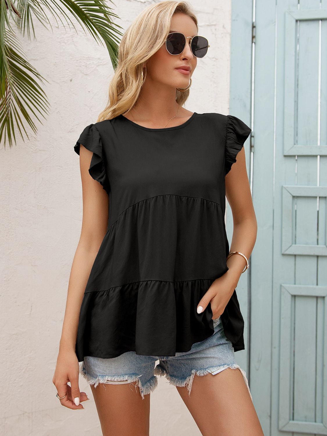 Black tiered blouse with round neck and short flutter sleeves