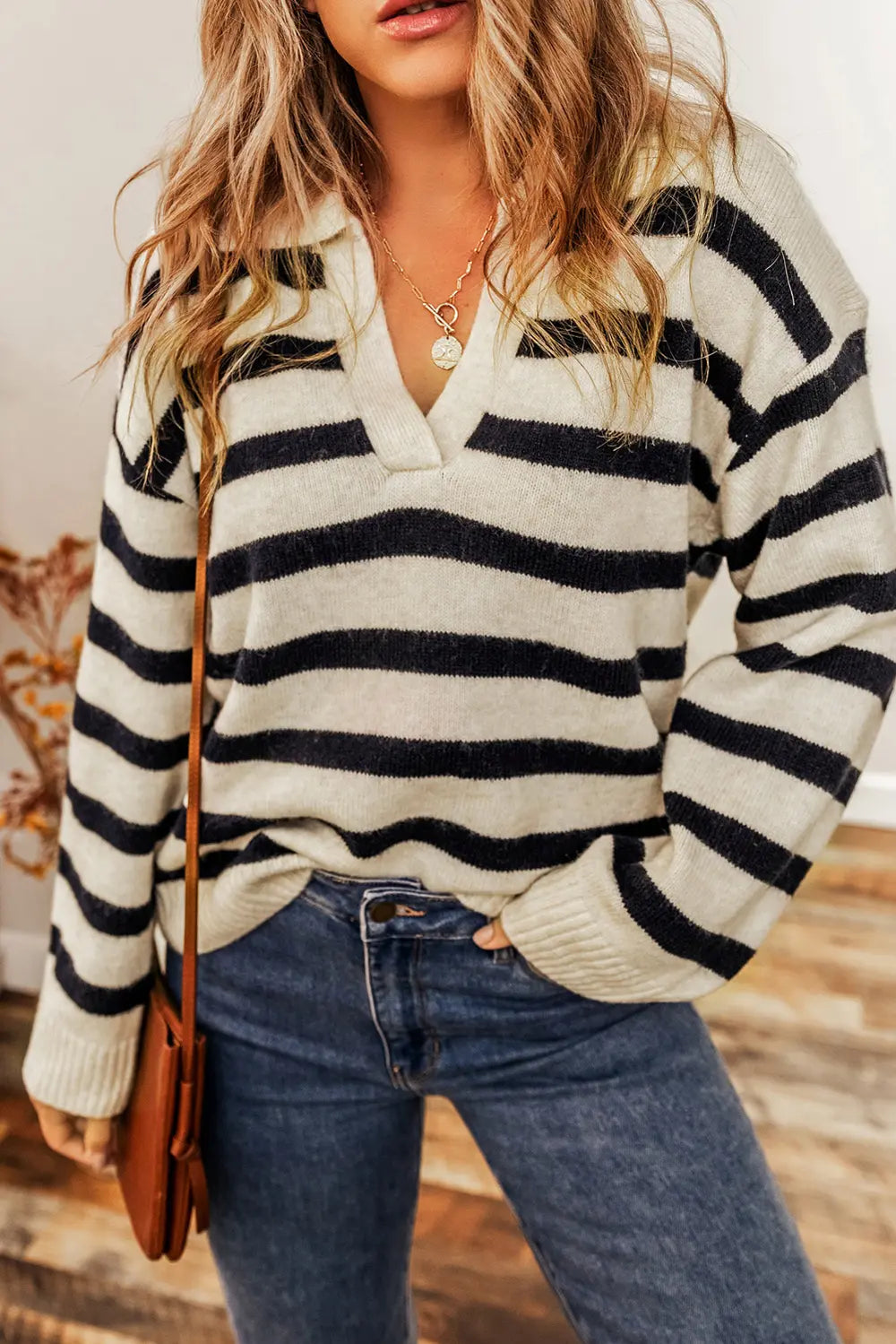 Striped collared knit sweater with long sleeves, cream base with black stripes