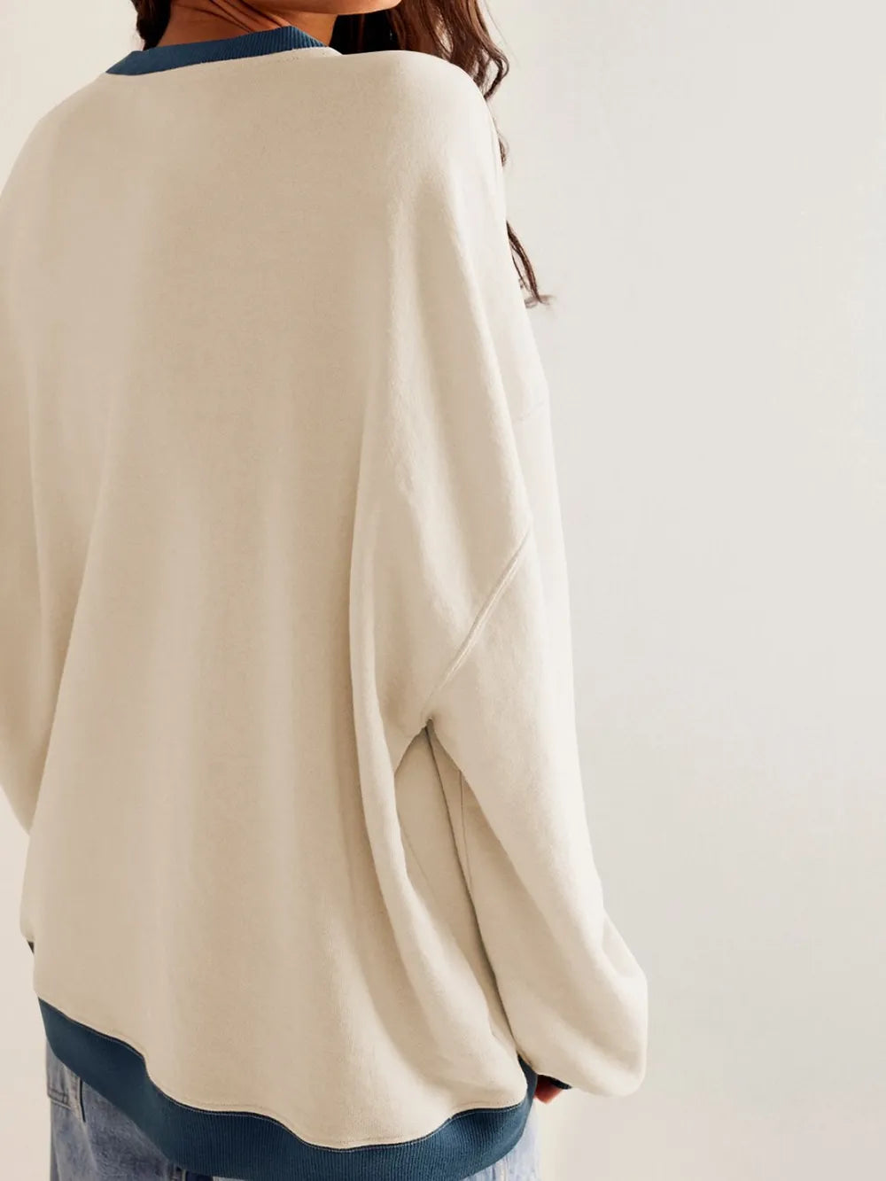 Beige round-neck sweatshirt with dark blue contrast trim at hem and cuffs