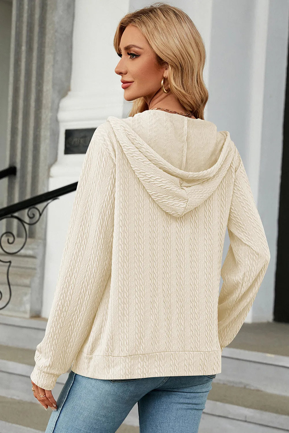 Cream zip-up hoodie with hood and long sleeves, textured knit back view