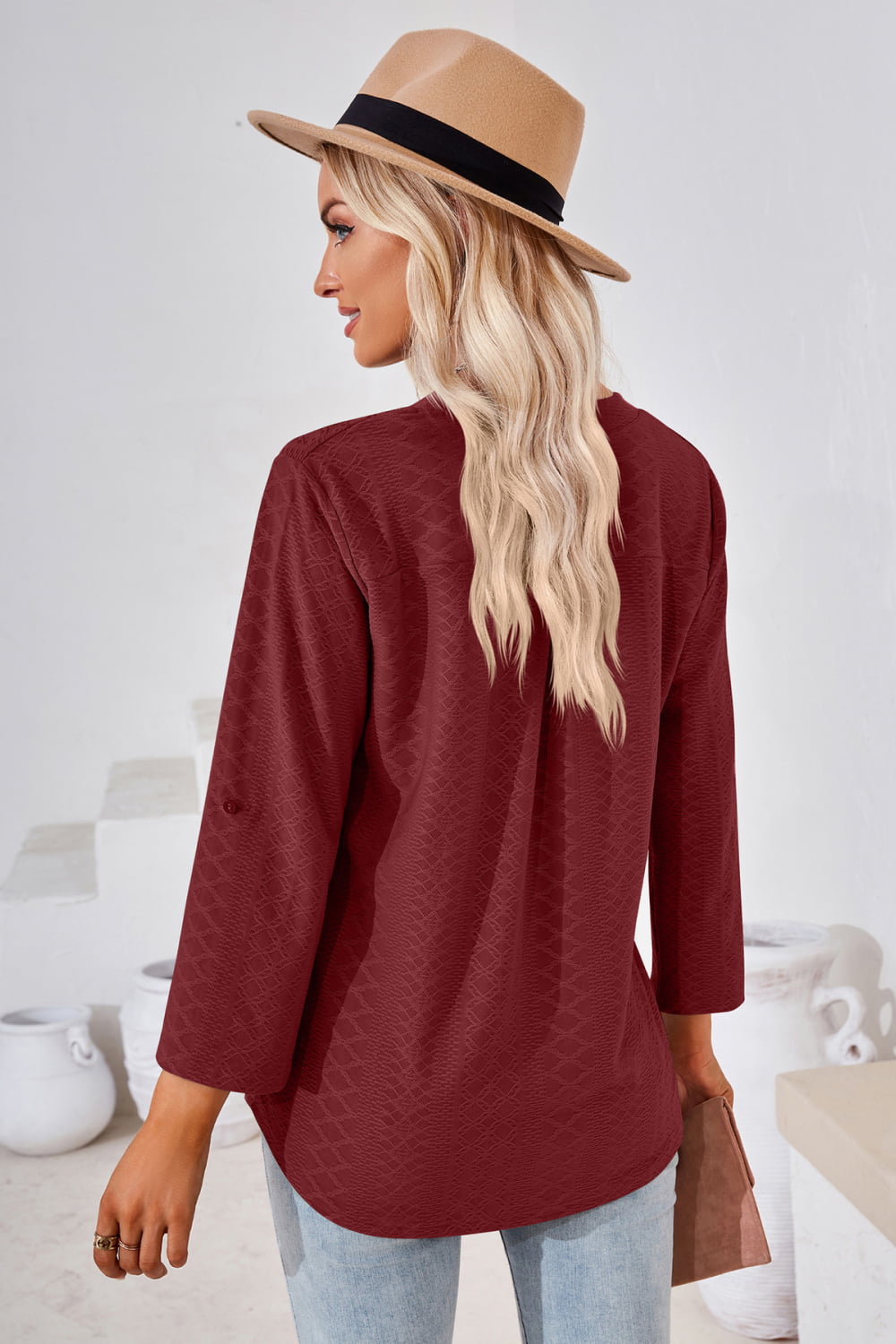 Burgundy V-neck blouse with rolled 3/4 sleeves, back view