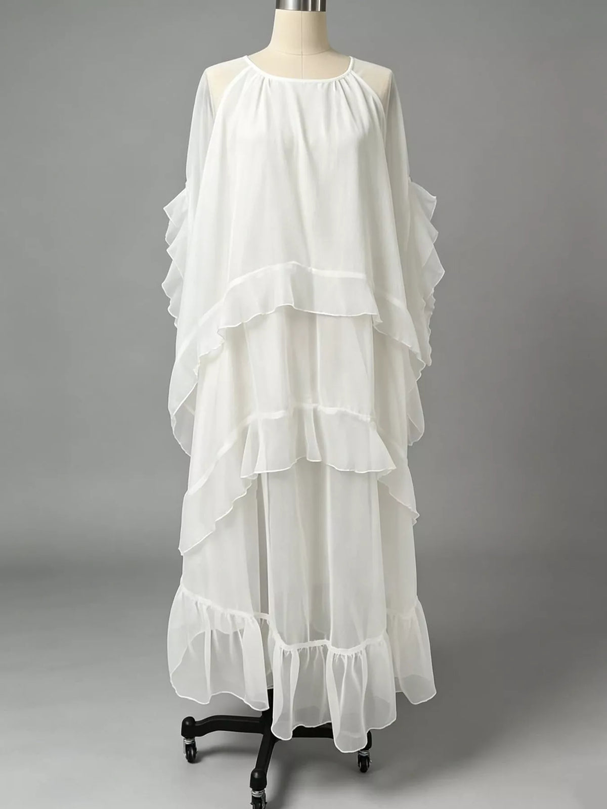 White ruffled layered maxi dress on mannequin with tiered flounce design