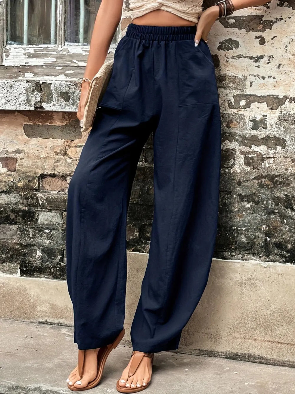 Dark blue elastic-waist wide-leg pants with side pockets and cuffed hem