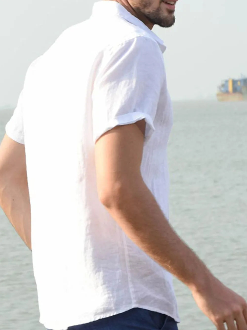 Men's short-sleeve button-down shirt, white, side view with short sleeves and buttons