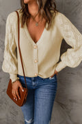 Cream openwork V-neck button-up cardigan with gold buttons and long sleeves