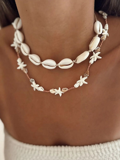 Double-layer shell charm necklace with starfish and cowrie shells, copper bead accents
