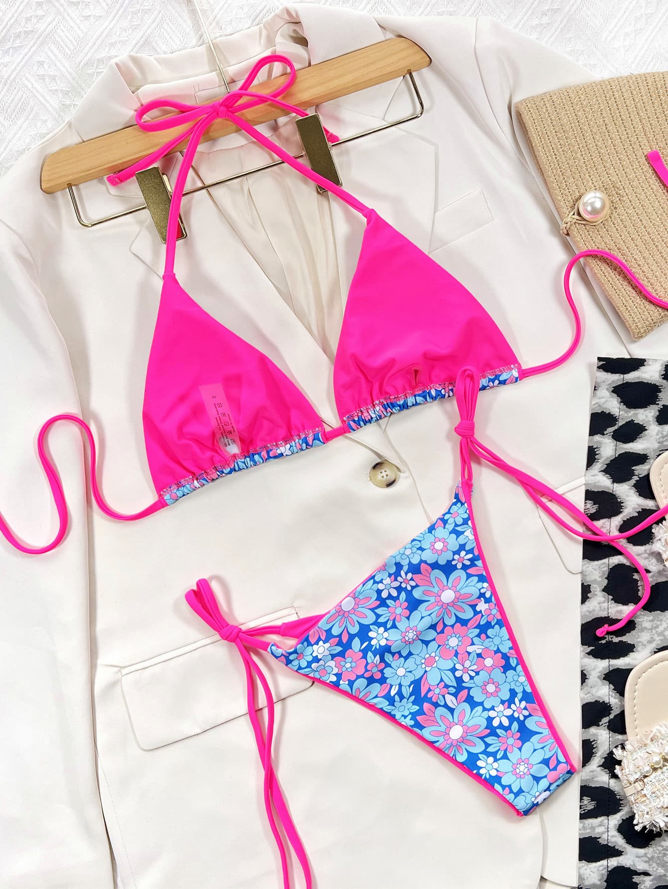 Pink and floral bikini set on a hanger: halter triangle top with matching tie-side