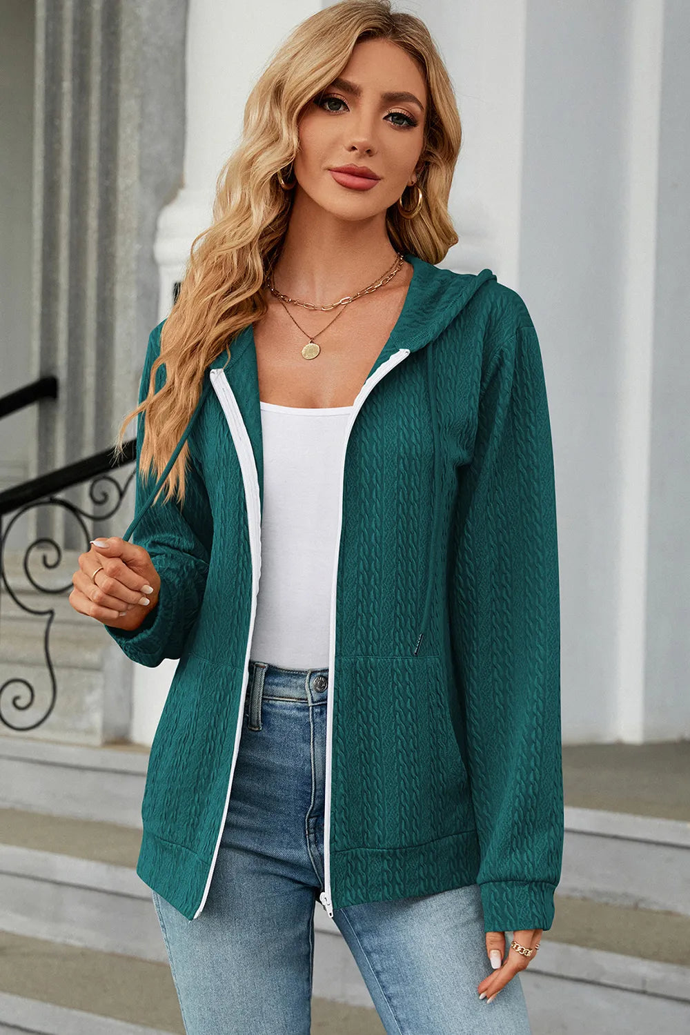 Turquoise drawstring zip-up hoodie with hooded neckline and white-trim front zipper
