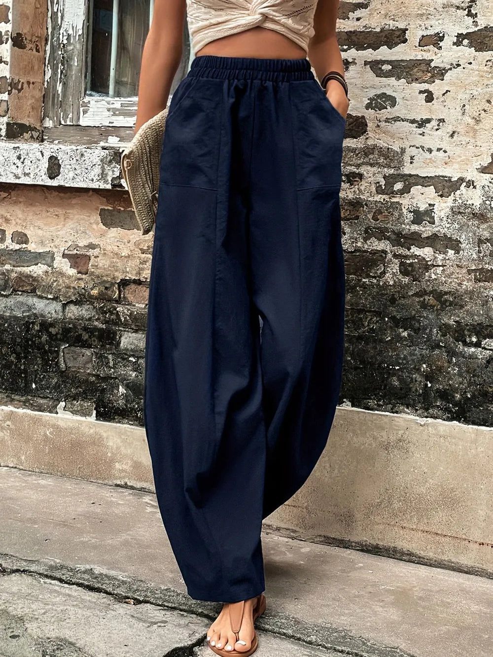 Dark blue high-rise elastic-waist pants with side pockets and loose wide-leg