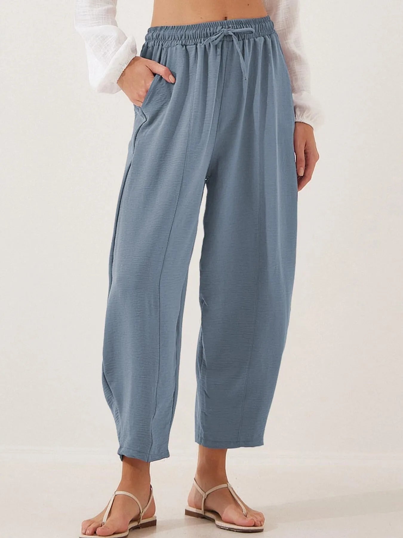 Blue drawstring wide-leg cropped pants with elastic waistband and relaxed drape