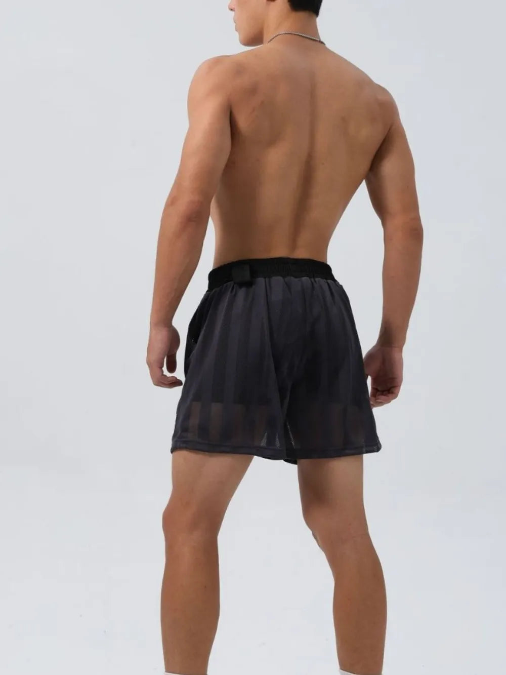 Black elastic waist mesh shorts with drawstring, rear view