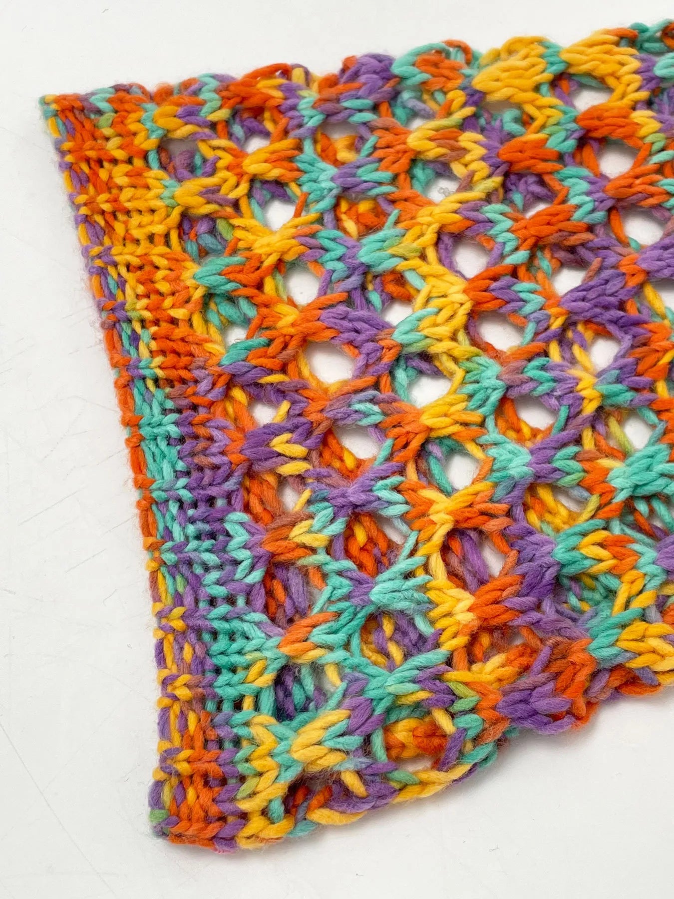 Multicolor crochet hollow-out stitch panel on cropped sweater hem