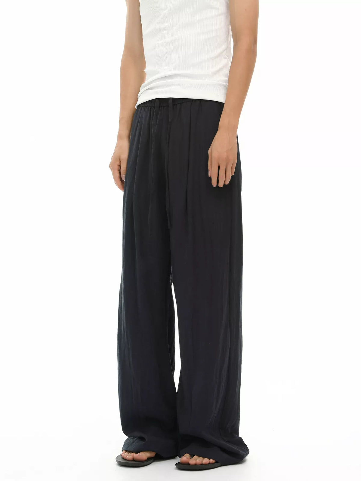 Black wide-leg drawstring trousers with loose leg opening and elastic waist